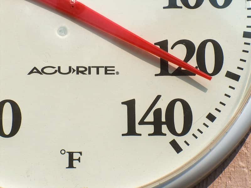 A thermometer showing 120 degrees Fahrenheit.